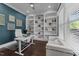 Bright home office features custom built-in shelves and modern decor at 1037 Lila Ln, Raleigh, NC 27614