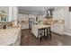 Spacious kitchen with white cabinets, granite countertops, stainless steel appliances, and large island at 1037 Lila Ln, Raleigh, NC 27614