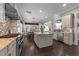 Spacious kitchen boasts stainless steel appliances, granite countertops, a center island, and hardwood flooring at 1037 Lila Ln, Raleigh, NC 27614