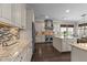 Gourmet kitchen with center island, stainless appliances, granite countertops and tile backsplash, perfect for cooking at 1037 Lila Ln, Raleigh, NC 27614