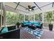Relaxing screened porch with comfortable seating and ceiling fan at 1037 Lila Ln, Raleigh, NC 27614