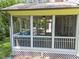 Relaxing screened porch boasts comfortable seating and serene outdoor views at 1037 Lila Ln, Raleigh, NC 27614