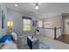Cozy second-story sitting area features natural light, plush decor and modern chandelier at 1037 Lila Ln, Raleigh, NC 27614