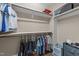 This walk-in closet features hardwood floors, a plethora of adjustable shelving, and hanging racks for clothing at 1037 Lila Ln, Raleigh, NC 27614
