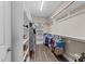This walk-in closet features hardwood floors, a plethora of adjustable shelving, and hanging racks for clothing at 1037 Lila Ln, Raleigh, NC 27614