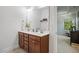 Bathroom featuring double sink vanity, large mirror, and neutral color palette at 1041 Cotulla Dr, Morrisville, NC 27560