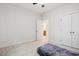 Minimalist bedroom with neutral carpet, double closet, and a view to ensuite bath at 1041 Cotulla Dr, Morrisville, NC 27560