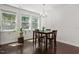 Bright dining area featuring hardwood floors, large windows, and a modern chandelier for ambiance at 1041 Cotulla Dr, Morrisville, NC 27560