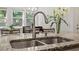 Close-up of a kitchen sink with granite countertops and a stainless steel faucet at 1041 Cotulla Dr, Morrisville, NC 27560