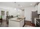Modern kitchen featuring granite countertops, stainless steel appliances, and an adjacent dining area at 1041 Cotulla Dr, Morrisville, NC 27560