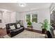 Cozy living room with hardwood floors, a comfortable leather sofa, and lots of natural light at 1041 Cotulla Dr, Morrisville, NC 27560