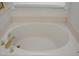 Large soaking tub with gold fixtures at 10461 Dapping Dr, Raleigh, NC 27614