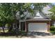 Charming two-story brick home with a two-car garage and mature landscaping at 10461 Dapping Dr, Raleigh, NC 27614