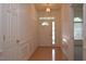 Bright foyer with hardwood floors, wainscoting, and decorative glass door at 10461 Dapping Dr, Raleigh, NC 27614