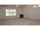 Spacious living room with plush carpeting, fireplace, and large windows at 10461 Dapping Dr, Raleigh, NC 27614