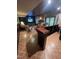 Finished basement bar with tv, beverage center, shelving, and additional seating area at 10505 Winding Wood Trail Trl, Raleigh, NC 27613