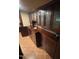 Elegant basement bar with dark wood cabinetry and copper sink at 10505 Winding Wood Trail Trl, Raleigh, NC 27613