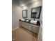 Bathroom with dual sinks, black granite counters, and modern fixtures at 10505 Winding Wood Trail Trl, Raleigh, NC 27613