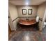Bathroom with copper tub, tile floors, and elegant decor at 10505 Winding Wood Trail Trl, Raleigh, NC 27613