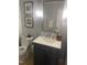 Well-lit bathroom with a modern vanity, framed mirror, elegant lighting, and toilet with neutral wall color at 10505 Winding Wood Trail Trl, Raleigh, NC 27613