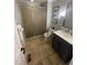Bright bathroom featuring a modern vanity, toilet, a glass-enclosed shower, and a framed mirror at 10505 Winding Wood Trail Trl, Raleigh, NC 27613
