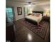 Comfortable bedroom featuring hardwood floors, ceiling fan, and natural light from large windows at 10505 Winding Wood Trail Trl, Raleigh, NC 27613
