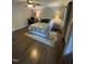 Charming bedroom with hardwood floors, cozy rug, and natural light from the large windows at 10505 Winding Wood Trail Trl, Raleigh, NC 27613