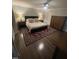 Cozy bedroom boasts hardwood floors, ceiling fan, and a queen-size bed with plush bedding at 10505 Winding Wood Trail Trl, Raleigh, NC 27613