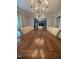 Dining room featuring hardwood floors, a decorative chandelier, and a large dining table at 10505 Winding Wood Trail Trl, Raleigh, NC 27613