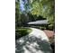 Long driveway leading to a charming home surrounded by trees at 10505 Winding Wood Trail Trl, Raleigh, NC 27613