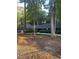 Home exterior showcasing a well-manicured lawn and mature trees at 10505 Winding Wood Trail Trl, Raleigh, NC 27613