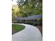 Inviting home exterior featuring lush greenery and a curved driveway at 10505 Winding Wood Trail Trl, Raleigh, NC 27613