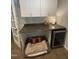 Functional flex space with built-in cabinets, workspace, a mini-fridge, and a cozy pet bed at 10505 Winding Wood Trail Trl, Raleigh, NC 27613