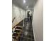 Well-lit hallway with tile flooring connects various areas of the home at 10505 Winding Wood Trail Trl, Raleigh, NC 27613