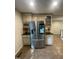 Kitchen with stainless steel refrigerator featuring smart screen, granite countertops, and custom cabinets at 10505 Winding Wood Trail Trl, Raleigh, NC 27613