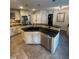 Spacious kitchen island featuring a black countertop, stainless steel appliances, and ample storage space at 10505 Winding Wood Trail Trl, Raleigh, NC 27613