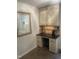 Cozy kitchenette features a black countertop, cabinetry with tiled backsplash, and modern appliances at 10505 Winding Wood Trail Trl, Raleigh, NC 27613