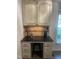Cozy kitchenette features a black countertop, cabinetry with tiled backsplash, and modern appliances at 10505 Winding Wood Trail Trl, Raleigh, NC 27613