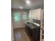 Well-organized laundry room equipped with modern washer and dryer units, ample cabinet space, and tile flooring at 10505 Winding Wood Trail Trl, Raleigh, NC 27613