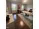 Bright office space with hardwood floors, large desk, and natural light from two windows at 10505 Winding Wood Trail Trl, Raleigh, NC 27613