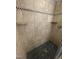 Close-up of a tiled shower featuring built-in shelving and modern fixtures with neutral tile at 10505 Winding Wood Trail Trl, Raleigh, NC 27613