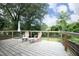 The back deck features wooden chairs, a small table, and faces a wooded backyard at 106 Eugene St, Carrboro, NC 27510