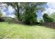 Large, grassy backyard enclosed by a wood privacy fence and mature trees, offering a serene outdoor space at 106 Eugene St, Carrboro, NC 27510