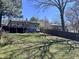 Lush backyard with a spacious deck, perfect for enjoying the outdoors, with mature trees and privacy fence at 106 Eugene St, Carrboro, NC 27510