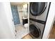 Compact bathroom with modern fixtures including a vanity, toilet, tub/shower combo, and convenient washer/dryer at 106 Eugene St, Carrboro, NC 27510