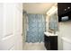 Well-lit bathroom with a dark vanity, patterned shower curtain, and decorative mirror for a cozy, inviting space at 106 Eugene St, Carrboro, NC 27510