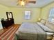 Cozy bedroom with ceiling fan, neutral walls, and a comfortable bed with natural light at 106 Eugene St, Carrboro, NC 27510