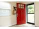 Entryway features a vibrant red door, modern flooring, and a coat rack for added convenience at 106 Eugene St, Carrboro, NC 27510