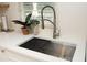Modern kitchen sink with stainless steel faucet, white countertops, and a charming decorative plant at 106 Eugene St, Carrboro, NC 27510