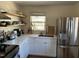 Bright kitchen featuring stainless steel appliances, white cabinetry, and open shelving at 106 Eugene St, Carrboro, NC 27510